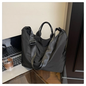 Detail of waterproof nylon tote bag with reinforced handles and adjustable shoulder strap