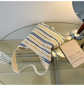 Detailed close-up of woven bucket bag featuring cream and blue stripes with hollow patterns