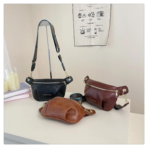 Three retro crossbody bags in black and brown with bohemian patterned shoulder straps