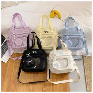 Detail view of heart-shaped window itabags in five colors with bow embroidery