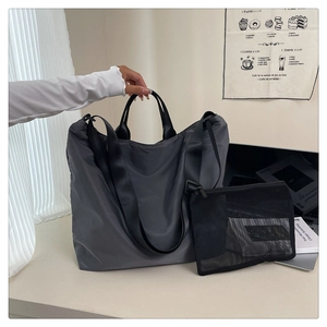 Waterproof grey tote bag detail showing large capacity and mesh zipper storage pouch
