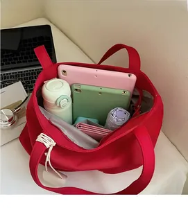 Interior view showing the large capacity and storage space of the red canvas tote bag