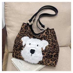 Close-up of leopard print tote bag with white plush schnauzer patch and black leather handles