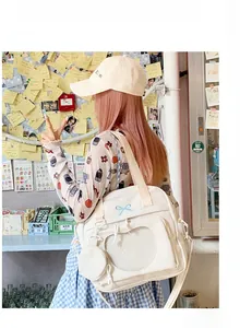 White canvas ITA bag with heart clear window and blue bow embroidery detail