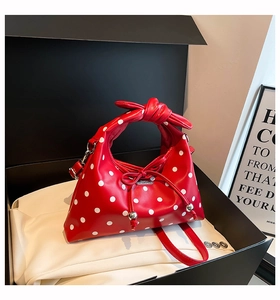 Red retro polka dot drawstring bag with silver metal charms in premium black gift box