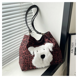 Close-up of leopard print tote bag with a unique plush white dog face patchwork