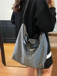 Minimalist grey waterproof tote bag with high-shine finish and black shoulder straps