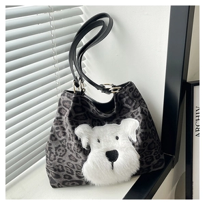 Detail of grey leopard print tote with white plush puppy patch and black handles