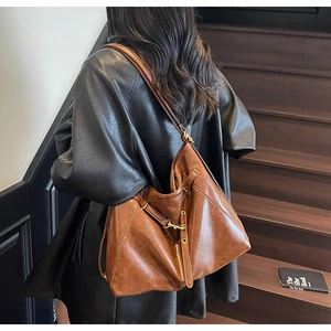 Detailed back view of a retro caramel leather tote bag worn over the shoulder