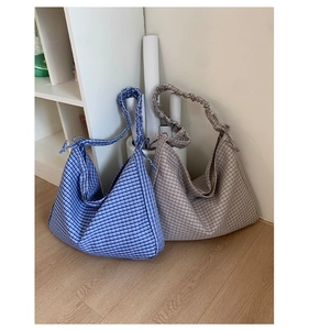 Detailed close-up of retro plaid hobo bags with unique scrunchie shoulder straps
