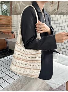 Close-up of the beige and brown striped hollow crochet knit texture on the shoulder bag