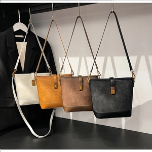 Macro shot showing four stylish bucket bags in white brown coffee and black leather