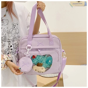 Detail of lavender nylon tote bag featuring a heart-shaped clear window and mini coin pouch