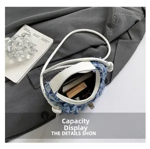 Top view of denim bucket bag interior showing capacity for smartphone and cosmetics