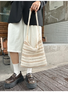 Detail of hand-woven crochet bucket bag with hollow mesh pattern and stripes