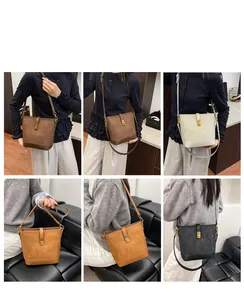 Detailed look at vintage bucket bags in multiple colors with adjustable straps and snaps