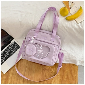 Detail view of purple canvas tote bag with transparent window and bow embroidery