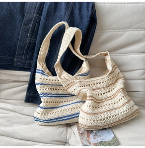 Detailed close-up of hollow knit crochet shoulder bag with stylish striped patterns