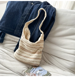 Detail of crochet shoulder bag with beige and brown stripes and soft interior lining