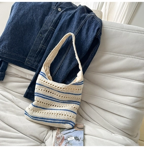 Close-up of handmade crochet hobo bag with ivory cotton mesh and navy blue stripes