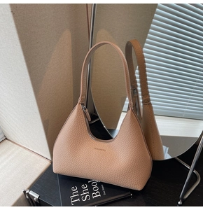 Close-up of litchi texture leather and metal zipper on hobo shoulder bag