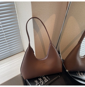 Detail of dark brown lychee leather hobo shoulder bag with a stylish half-moon design