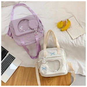Detail of Ita Bag with clear heart window, ribbon embroidery, and matching mini coin purse
