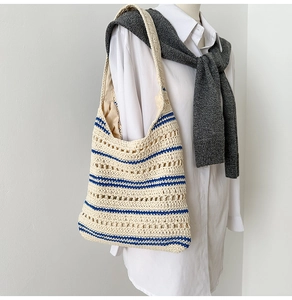 Detail of hand-woven shoulder bag with blue stripes and hollow mesh pattern