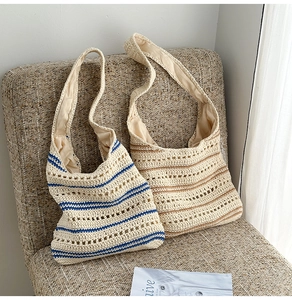 Detail of hollow woven shoulder bags in beige cotton with striped crochet texture