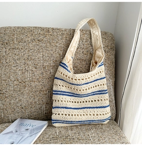 Detailed close-up of handmade hollow crochet weave texture on a striped shoulder tote bag
