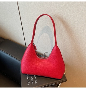 Close-up of the pebbled red leather texture and metallic zipper on this Hobo bag