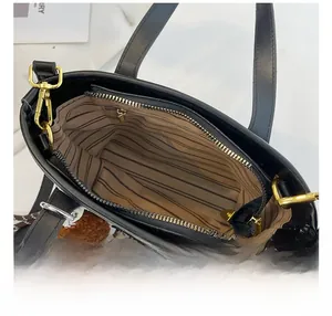 Top view of bucket bag interior with striped fabric lining and gold zipper detail