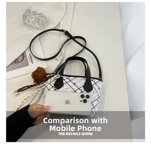 Size comparison of a plaid bucket bag with smartphone and cute bear charm detail