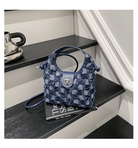 Close-up of denim bucket bag with checkerboard pattern and frayed edges texture
