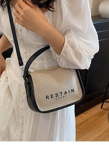 Chic beige canvas crossbody bag with black leather trim and shoulder strap for women
