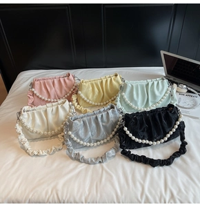 Détail de six sacs nuages plissés aux couleurs pastel avec des bandoulières en perles