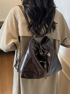 Brown oil wax leather bucket bag with drawstring, versatile shoulder and backpack design