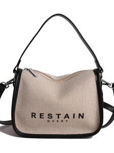 Minimalist beige canvas crossbody bag with black leather trim and top handles for women