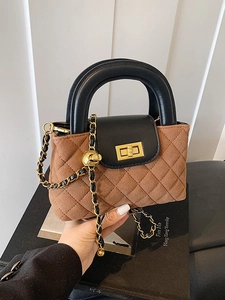 Brown quilted crossbody bag with black handle and gold chain strap in a retro style