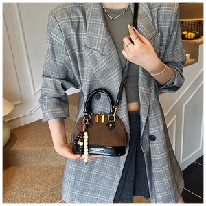 Brown frosted leather shell bag with beaded charm on a grey plaid blazer outfit