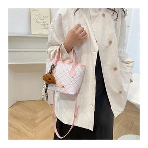 Pink and white checkered bucket bag featuring a detachable strap and cute bear charm
