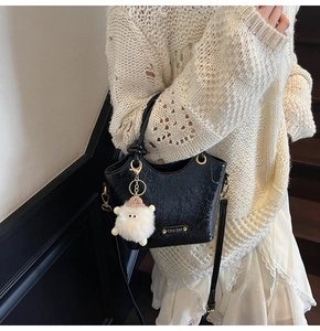 Fashionable black wrinkled texture bucket bag styled with an elegant sheep pendant