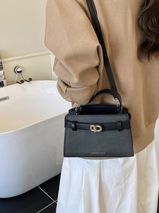 Chic black faux leather crossbody bucket bag with gold twist lock and shoulder strap