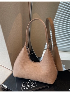 Minimalist camel leather crescent shoulder bag with zipper and logo in elegant scene