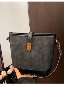 Chic black bucket bag with vintage gold hardware and dual texture finish for women