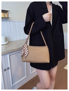 Close-up of brown woven shoulder bag with V-pattern texture and polka dot scarf detail