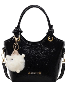 Retro black glossy patent leather handbag with gold hardware and white pompom charm