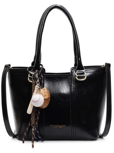 Retro black leather bucket bag with sport charms and shoulder strap on white background