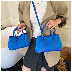 Blue faux suede bucket bags in two sizes featuring dual handles and metal buckles