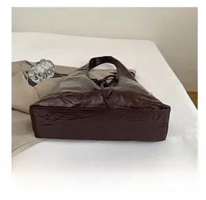Detailed bottom view of the large faux leather tote bag showing durable wide base structure